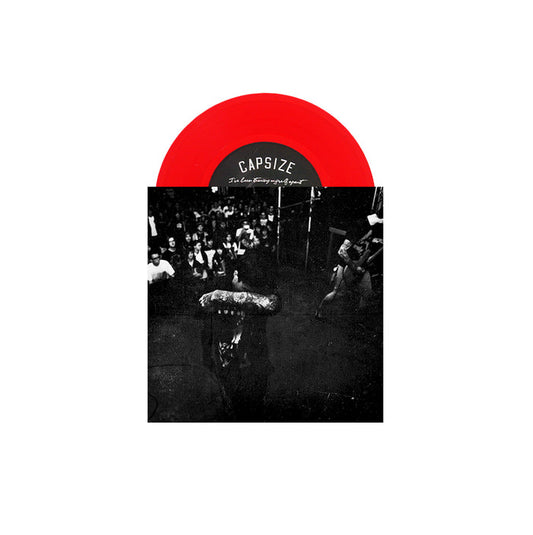 A limited pressing transparent red vinyl from Capsize is partially visible above a black-and-white album cover featuring a tattooed performer singing to a crowd at a live Capsize concert.