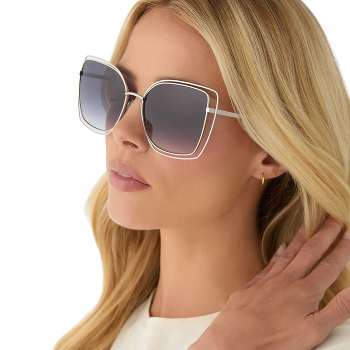 on model - female wearing diff eyewear featuring the jacqueline square sunglasses with a silver frame and grey gradient lenses angled view
