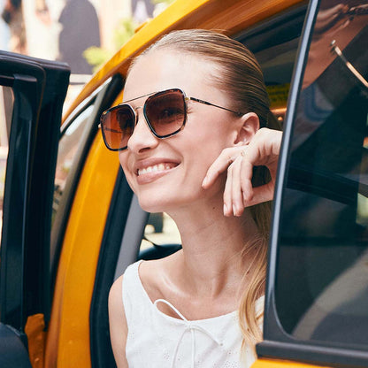 lifestyle - Model smiling getting out of a taxi wearing the Jordan Confetti Tortoise womens navigator sunglasses by DIFF Eyewear