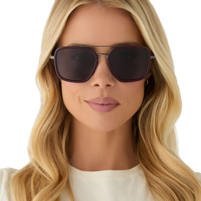 on model - female wearing diff eyewear featuring the jordan navigator sunglasses with a dark cherry lacquer frame and grey gradient polarized lenses front view
