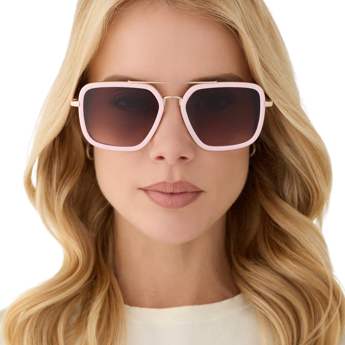 on model - female wearing diff eyewear featuring the jordan navigator sunglasses with a powder pink with gold frame and brown gradient lenses front view