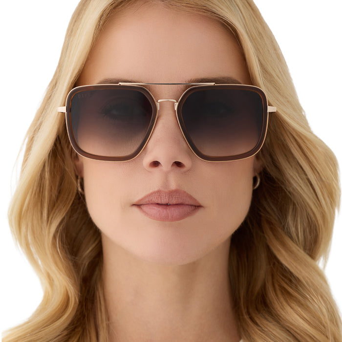 on model - female wearing diff eyewear featuring the jordan navigator sunglasses with a whiskey with gold frame and grey gradient lenses front view