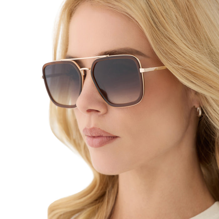 on model - female wearing diff eyewear featuring the jordan navigator sunglasses with a whiskey with gold frame and grey gradient lenses angled view