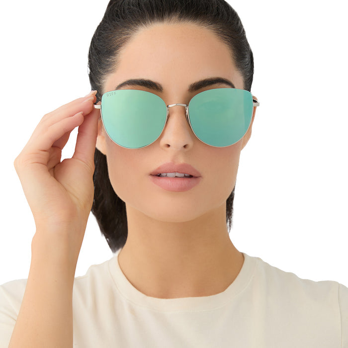 on model - female wearing diff eyewear kinsley round sunglasses with a silver metal frame and aquatic awe teal mirror lenses front view