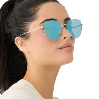 on model - female wearing diff eyewear kinsley round sunglasses with a silver metal frame and aquatic awe teal mirror lenses angled view