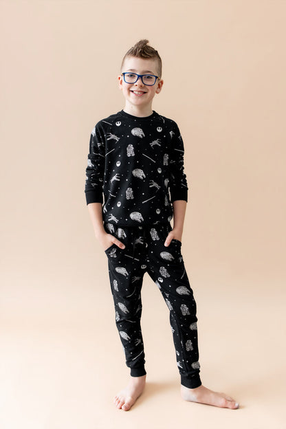 Young boy modeling the Long Sleeve Jogger Set in STAR WARS™ with his hands in the side pockets