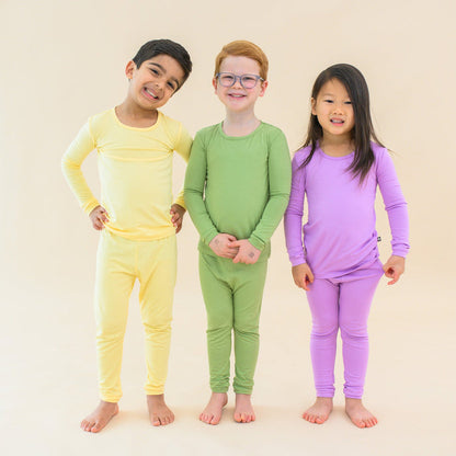 Toddlers in long sleeve pajamas in lilikoi, honu and poi