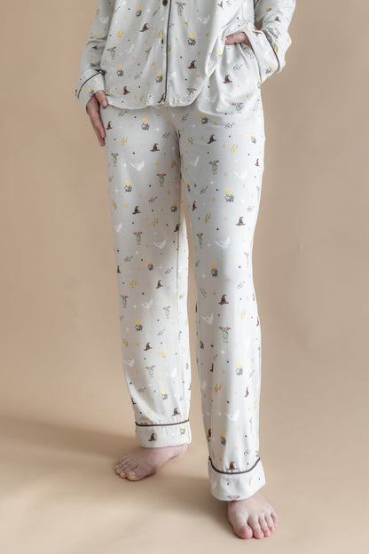 Person wearing a cream Long-Sleeved Women's Pajama Set pajama with Harry Potter prints on a beige background.