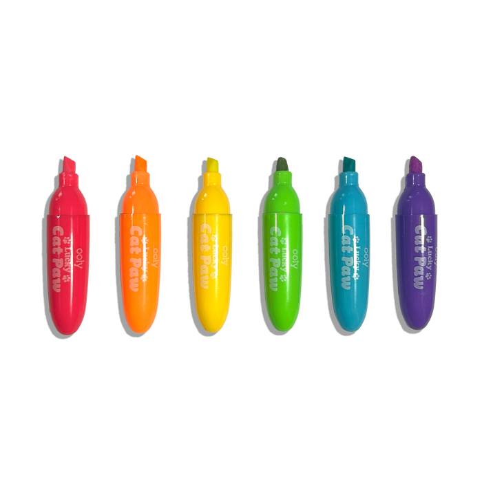 Row of uncapped OOLY Lucky Cat Paw Scented Neon Highlighters on a white background