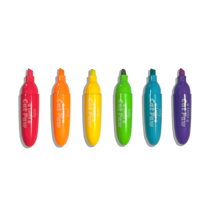 Row of uncapped OOLY Lucky Cat Paw Scented Neon Highlighters on a white background