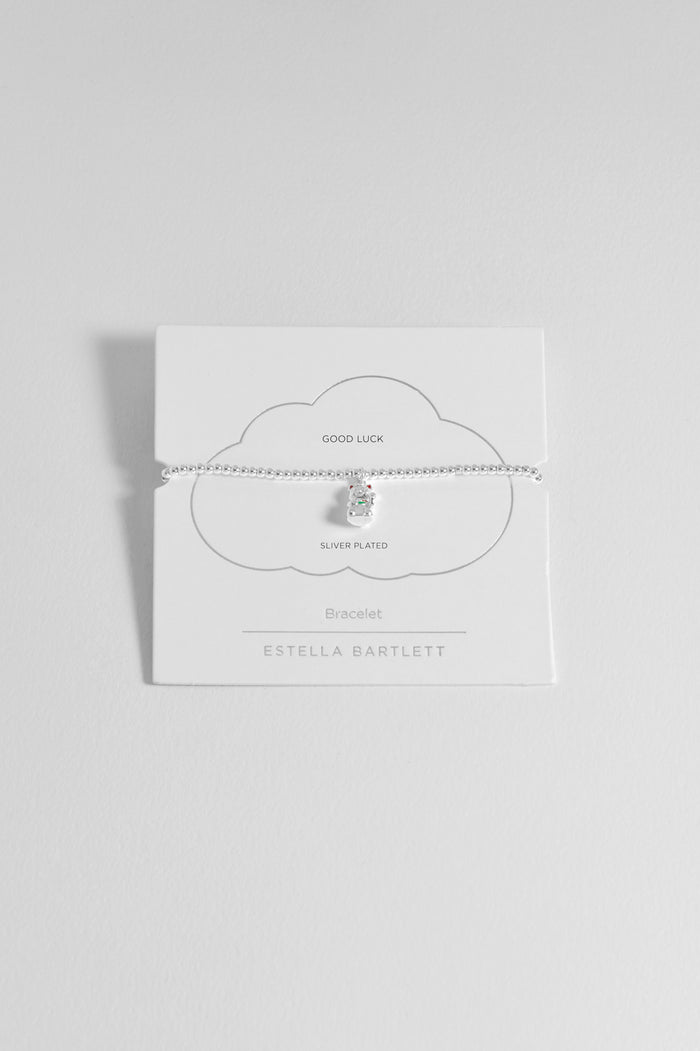 Silver necklace on a white card with 'Estella Bartlett' branding against a light gray background