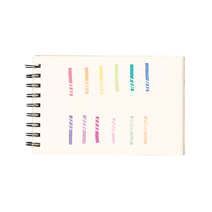 White sketchbook with 12 color swatches and eraser lines from the OOLY Make No Mistake Erasable Markers