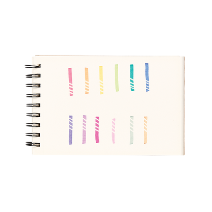 White sketchbook with 12 color swatches and eraser lines from the OOLY Make No Mistake Erasable Markers