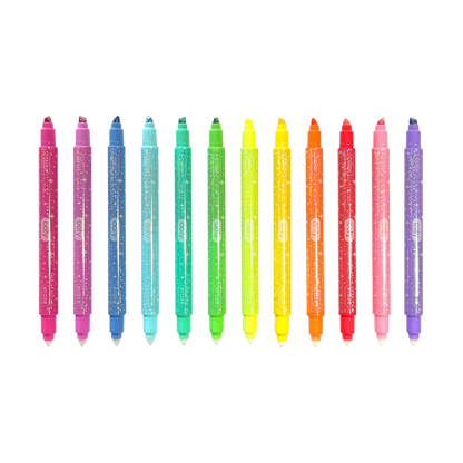 Row of uncapped OOLY Make No Mistake! Glittery Erasable Markers on a white background