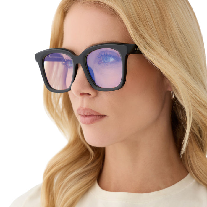 on model - blonde female wearing diff eyewear meredith square prescription glasses with a black acetate frame and grey lenses angled view