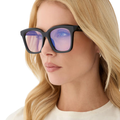 on model - blonde female wearing diff eyewear meredith square prescription glasses with a black acetate frame and grey lenses angled view