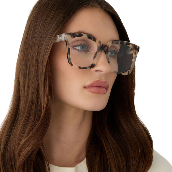 on model - female wearing diff eyewear featuring the meredith square glasses with a cream tortoise frame angled view