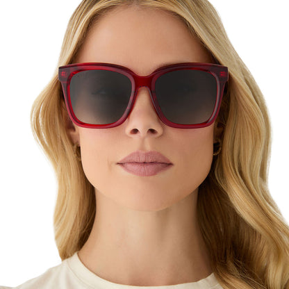 on model - female wearing diff eyewear featuring the meredith square sunglasses with a red hot summer frame and grey gradient polarized lenses front view
