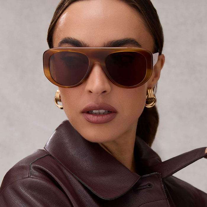 on model - female wearing diff eyewear featuring the morgan shield sunglasses with a tawny tortoise frame and brown lenses front view