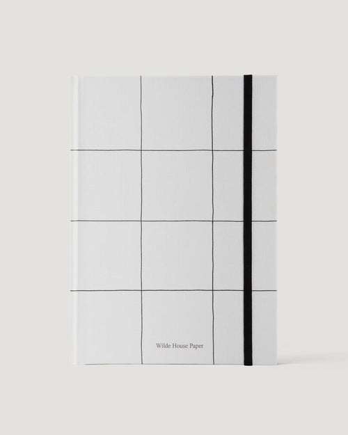 White notebook with grid pattern and black line on a white background