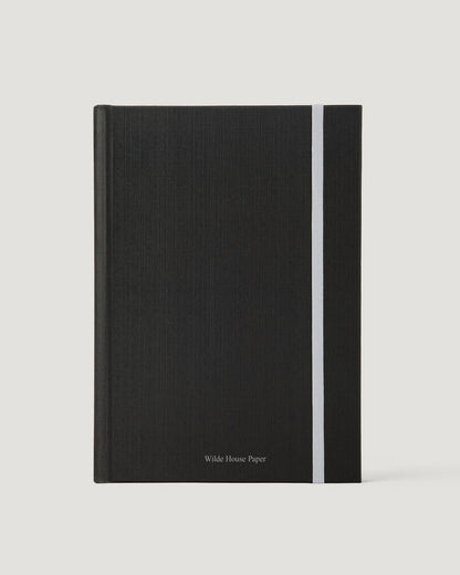 Black notebook with a white stripe on a light gray background