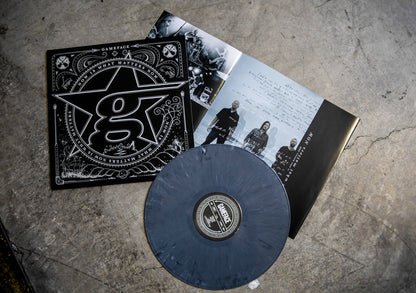 A Grey Marble vinyl record by Gameface rests on concrete beside its black and white album cover and an open booklet with band photos and notes—a Limited Pressing from Gameface.