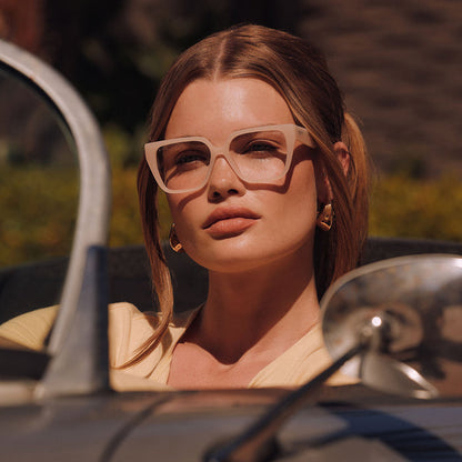 lifestyle - female driving wearing diff eyewear featuring the olive square prescription glasses with a milky blush frame
