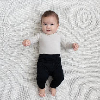 Baby modeling Pant in Midnight and Oat Long Sleeve Bodysuit