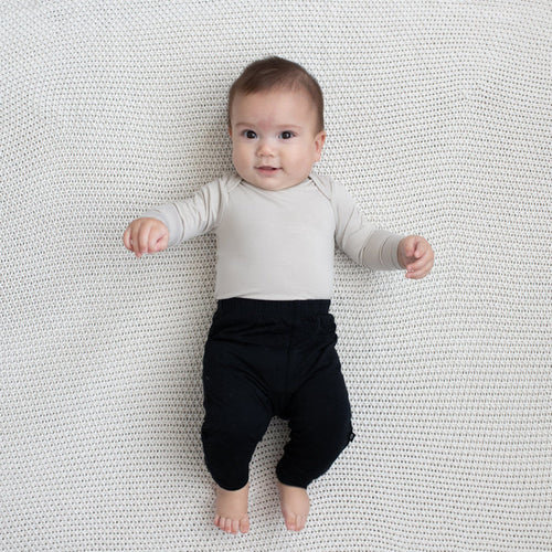 Baby modeling Pant in Midnight and Oat Long Sleeve Bodysuit