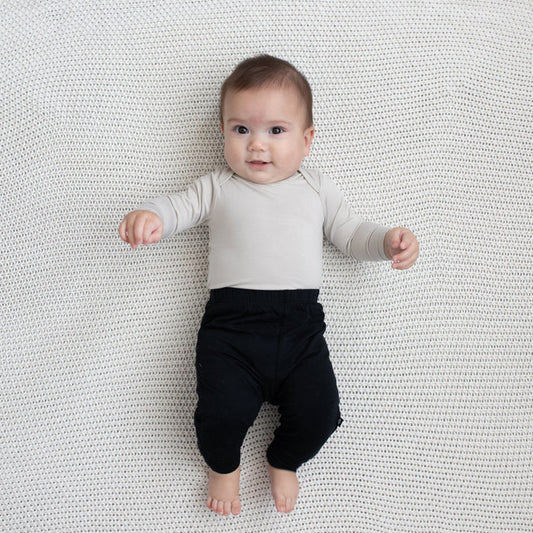 Baby modeling Pant in Midnight and Oat Long Sleeve Bodysuit