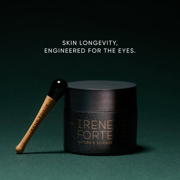 Black skincare jar with wooden applicator on a dark green background, featuring the brand 'Irene Forte'.