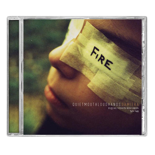 A close-up of a child's face with eyes covered by beige tape labeled FIRE in black marker. The background is blurred, and Damiera—the brand name—appears at the bottom.