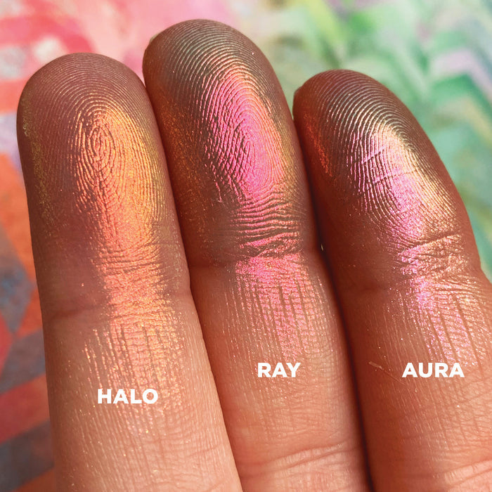 Left angled finger swatches of Ray Iridescent Multichrome Eyeshadow shifts compared to Halo, Aura