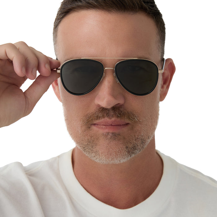 on model - male wearing yellowstone x diff eyewear featuring the yellowstone aviator sunglasses with a black frame and g15 polarized lenses front view