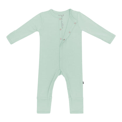 Flat lay of Kyte Baby Romper in Sage with top snaps opened