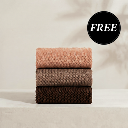 Kitsch Rosewood African Net Sponge set shown stacked in three terracotta tones, displaying the exfoliating mesh texture on a soft neutral background