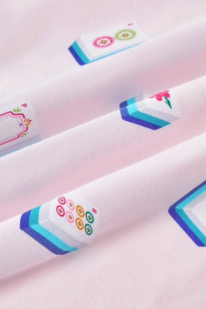 An all-over print featuring: white Mahjong tiles with a navy and turquoise back and various artworks; white jasmine flowers with pink centers and green leaves; white dice with pink, turquoise, and green markings; and pink teacups with navy trim, over a pale pink background color named Sakura.