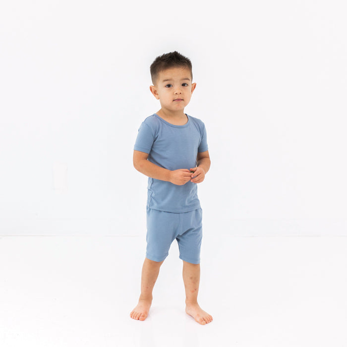 Child wearing the two piece Short Sleeve Toddler Pajama Set in Slate