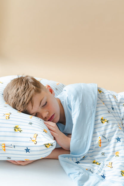 Young boy laying in a bed wearing the Standard Pillowcase in Amalfi Coast