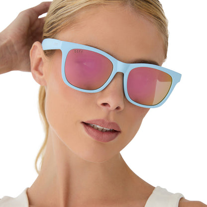 on model - female wearing diff sport featuring the storm square sunglasses with a matte baby blue frame and sherbert rainbow mirror polarized lenses front view