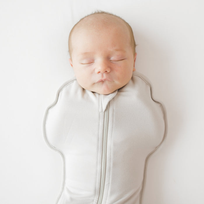 Close up of baby asleep in Swaddle Bag in Oat 0.5