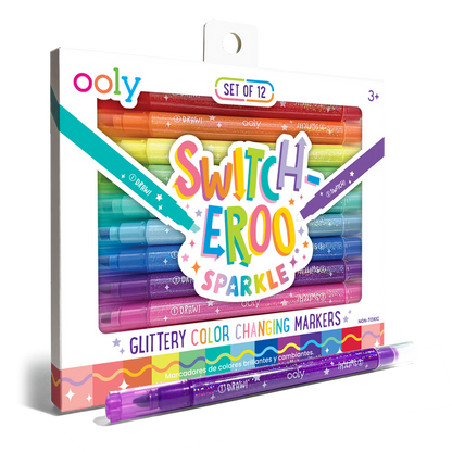 Quarter angle of packaging and purple pen from OOLY Switch-Eroo Sparkle Glittery Color Changing Markers