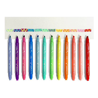 Row of uncapped markers and color changed swatches from OOLY Switch-Eroo Sparkle Glittery Color Changing Markers