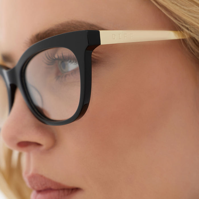on model - female wearing diff eyewear featuring the sylvia cat eye prescription glasses with a black frame detailed view