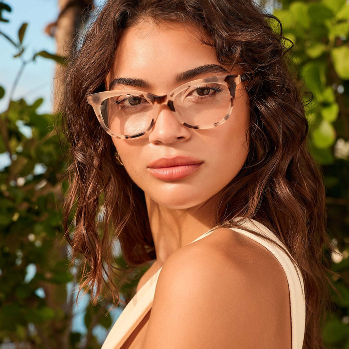 lifestyle - female outdoors wearing diff eyewear sylvia cat eye prescription glasses with a cream tortoise frame front view