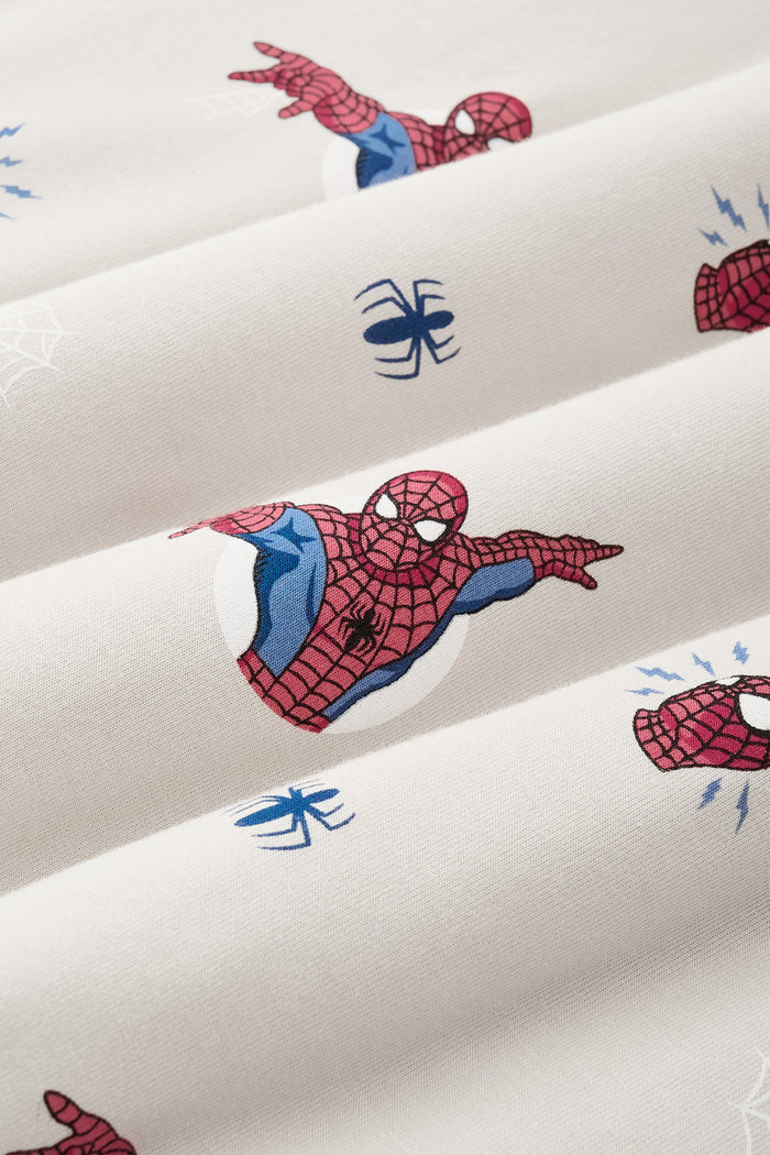 Close up of Oat color fabric with Spider-Man print