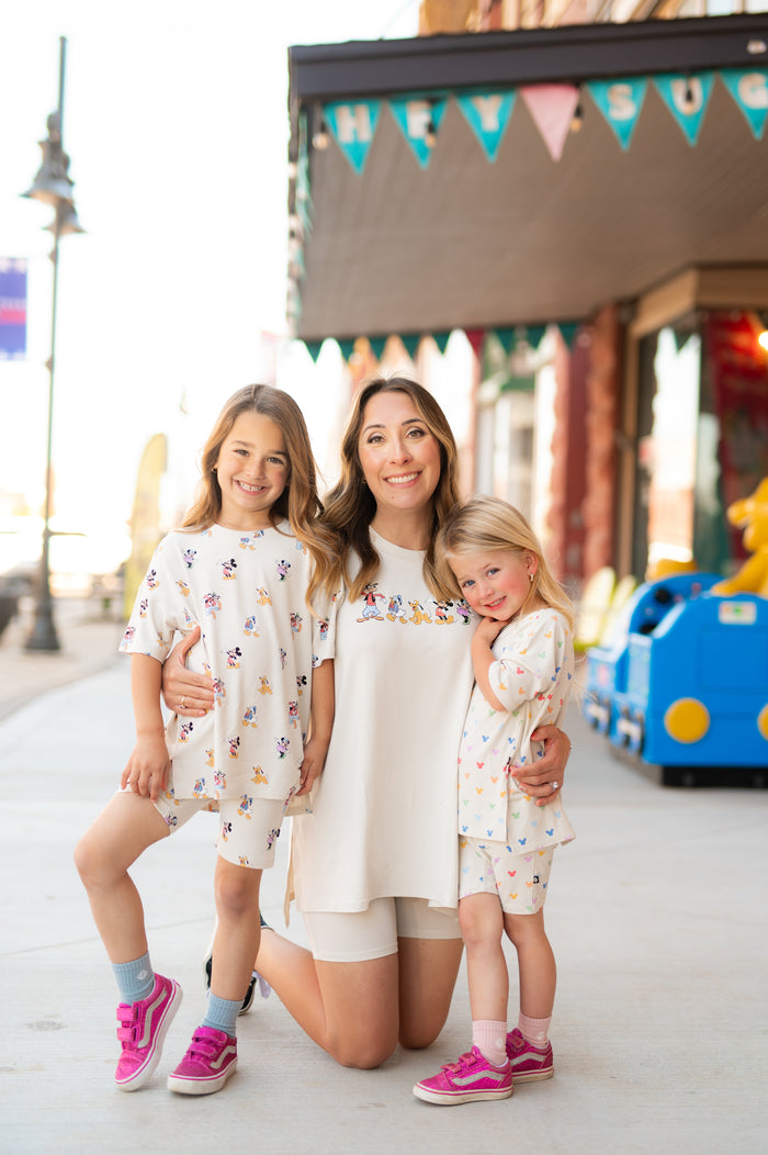 mom with 2 kids wearing biker short sets with mickey mouse patterns