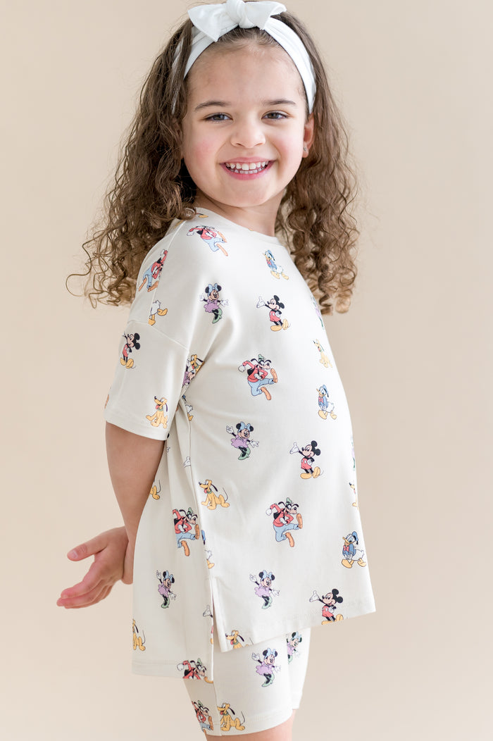 girl in oversized tee and biker short with a mickey mouse and friend pattern