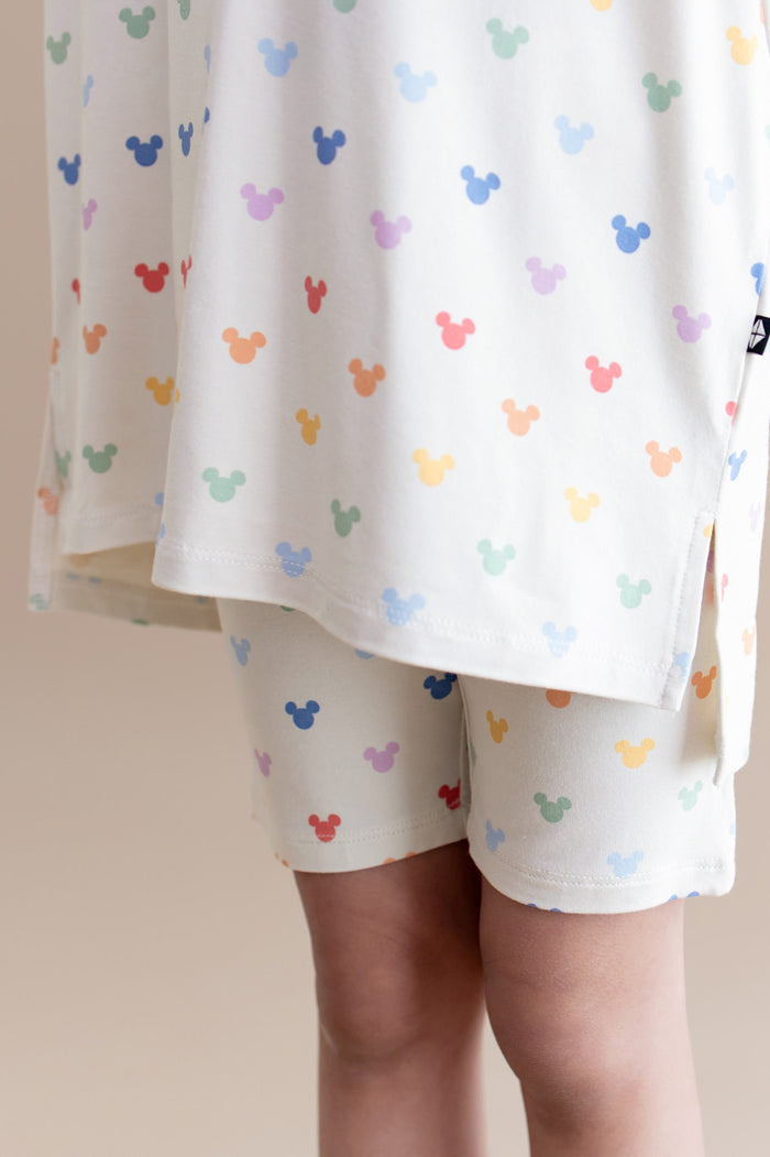 Children's outfit with colorful mickey mouse ears pattern on a plain background