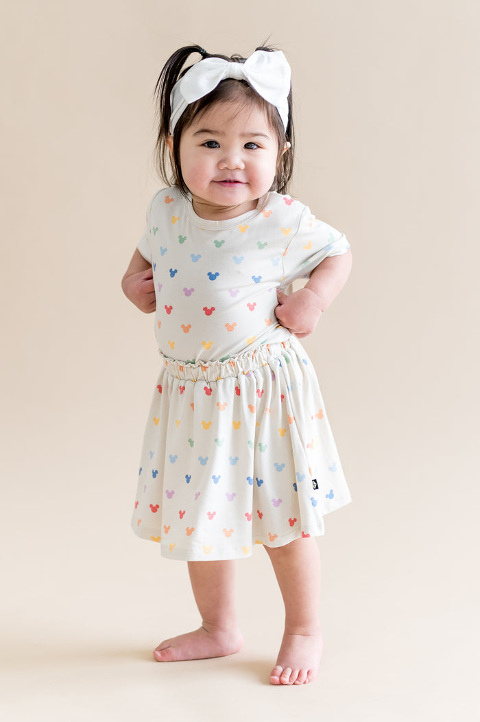 Toddler wearing a tshirt with matching skort with mickey mouse head pattern